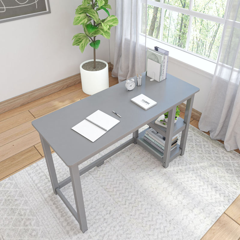 Modern home office setup with a gray desk surrounded by natural light, potted plant, and minimalistic decor.