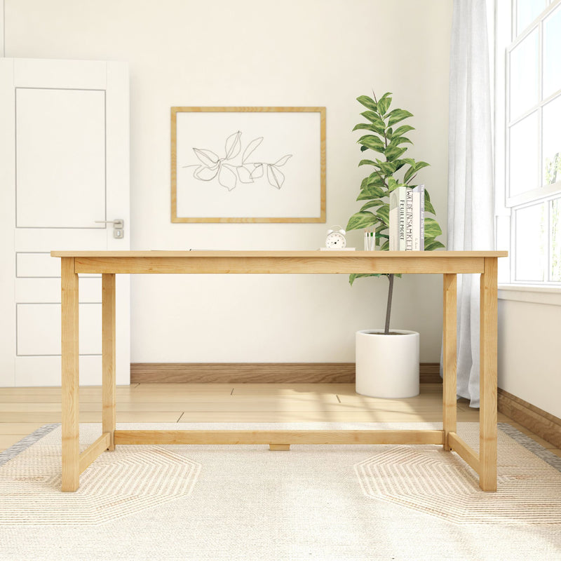 Minimalist home office setup with wooden desk, indoor plant, and modern decor near a window.