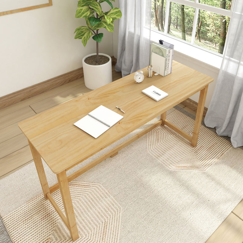 Modern home office setup with a minimalist wooden desk, notebook, and stylish potted plant near a window.