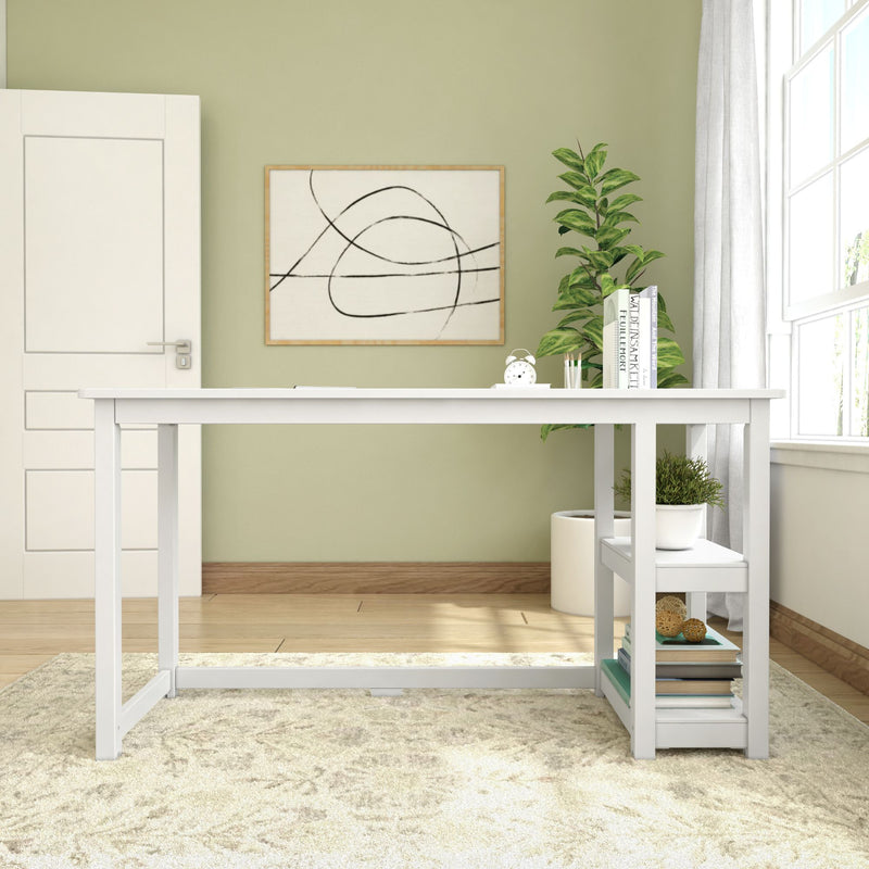 Modern white desk with minimalist decor, indoor plant, books, and abstract wall art in a bright home office setting.