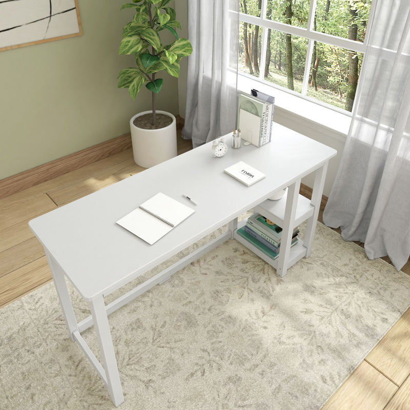 Minimalist white desk in a cozy home office with plant and books by a sunlit window.