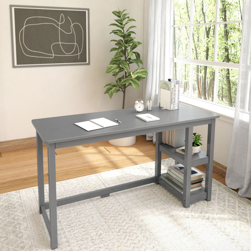 Minimalist home office with gray desk, potted plant, and natural light through large window.