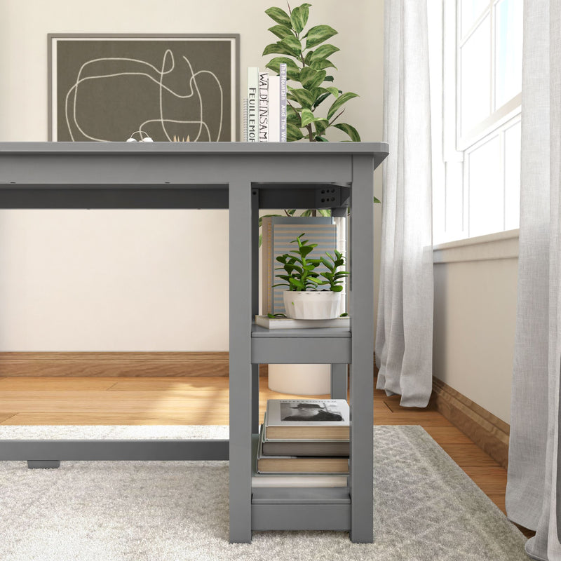 Modern home office desk with built-in shelves, houseplant, and books in bright room.