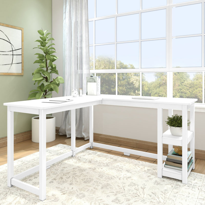 Modern white corner desk in bright home office with large windows and indoor plant.