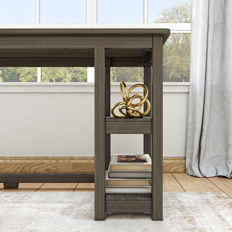 Modern wooden desk with decorative gold sculpture and books on shelf, in well-lit room with window view.