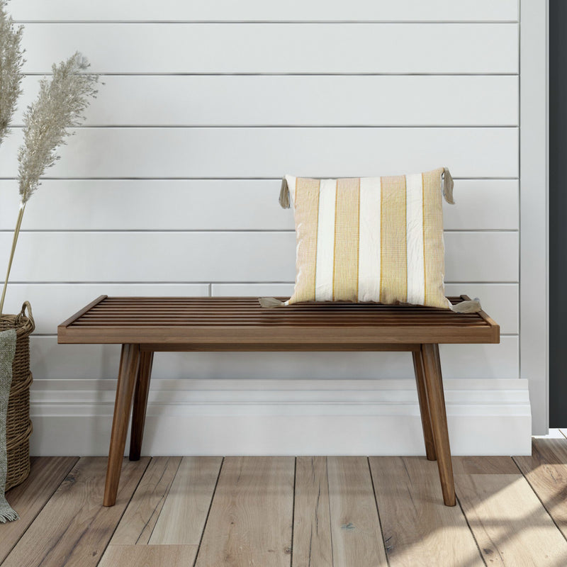 Wooden bench with decorative pillow in modern Scandinavian interior design.