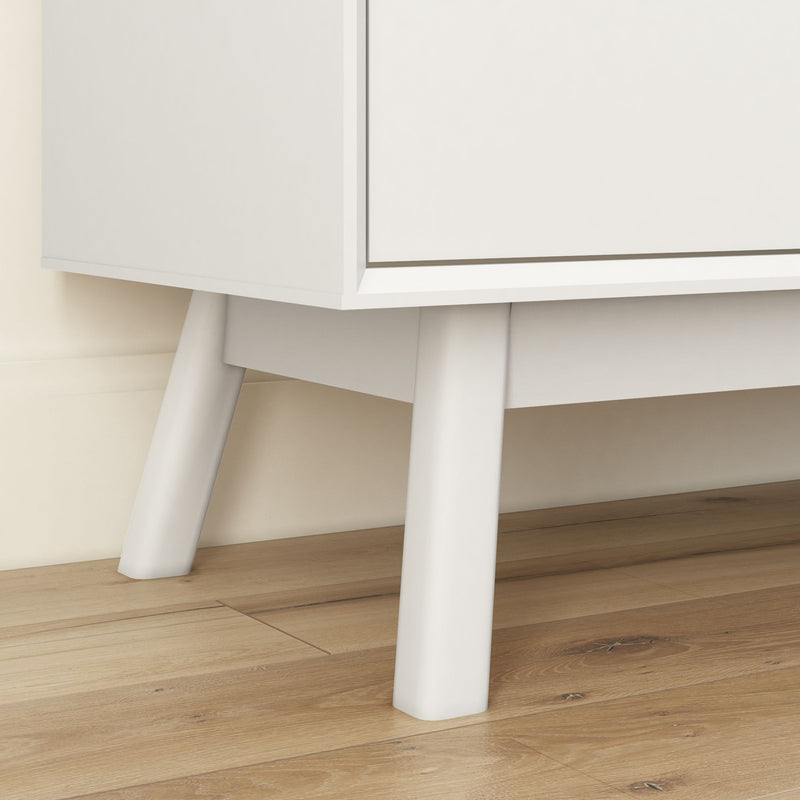 Modern white cabinet with sleek design and minimalist style on wooden floor.