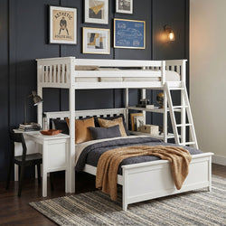 White loft bunk bed with ladder and built-in desk in a modern navy accent-wall kids bedroom with framed gallery art, layered bedding and textured rug