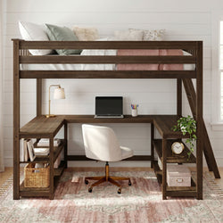 Twin-size wooden loft bed with built-in L-shaped desk, laptop workspace, shelving, brass desk lamp, trailing plant and decorative pillows against white shiplap wall