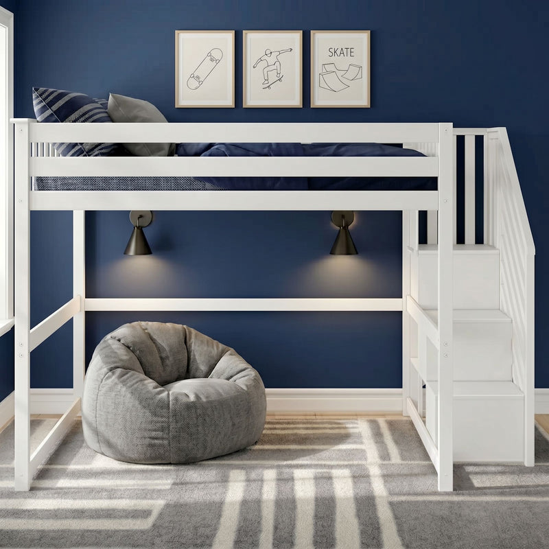 White loft bunk bed with stairs against navy blue wall, skateboard art, black wall sconces, gray bean bag and patterned gray rug in a modern kids' bedroom