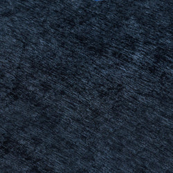 Close-up of dark navy blue textured velvet fabric with plush pile, carpet texture for upholstery and interior design