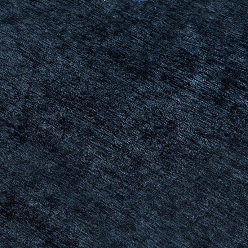Close-up of dark navy blue textured velvet fabric with plush pile, carpet texture for upholstery and interior design