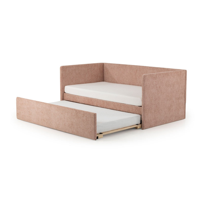 Pink velvet upholstered corner daybed with pull-out trundle and twin mattresses on white background