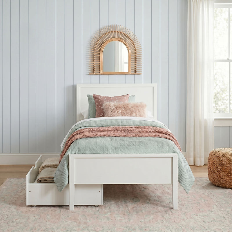 Cozy pastel twin bedroom with white storage bed, mint quilt, blush and faux-fur pillows, rattan sunburst mirror, shiplap wall and sheer curtains