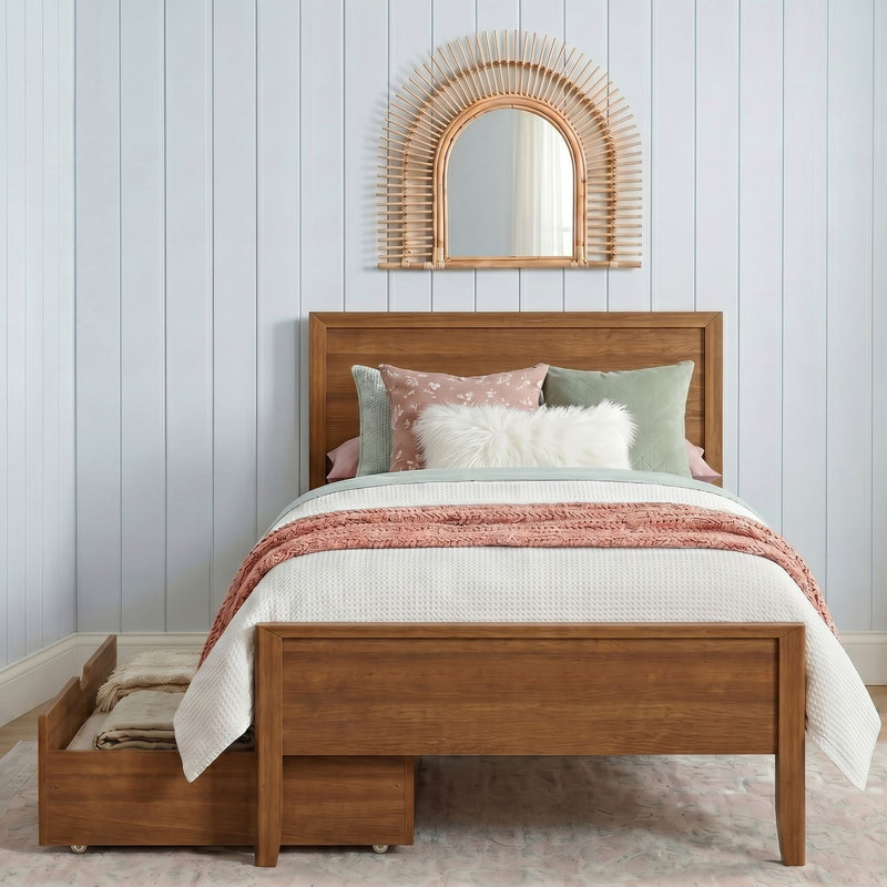 Cozy modern farmhouse bedroom with wooden bed frame, white waffle bedding, blush knit throw and pastel pillows, boho rattan sunburst mirror on light blue shiplap wall and under-bed storage drawers