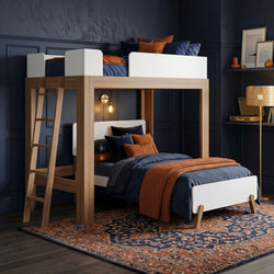 Modern wooden loft bunk bed in navy blue bedroom with orange knit throw, navy bedding, wooden ladder and patterned rug