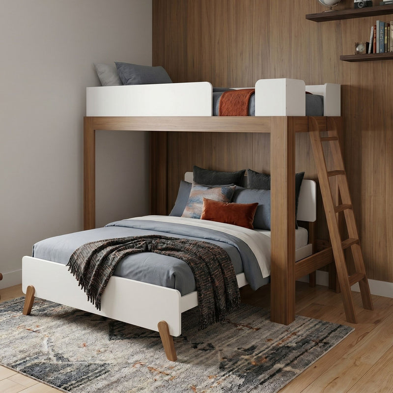 Modern wooden loft bunk bed with white guardrails and ladder, gray bedding and rust accent pillows in a kids' bedroom with wood-paneled wall and patterned area rug