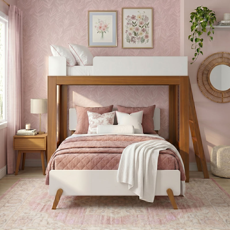 Pink girls bedroom with wooden loft bed, blush quilted bedding, floral wallpaper, framed botanical prints, boho rattan mirror and hanging pothos plant