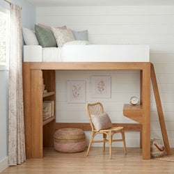 Wooden loft bed with built-in desk and shelves, rattan chair, pastel pillows and neutral farmhouse kids' bedroom decor