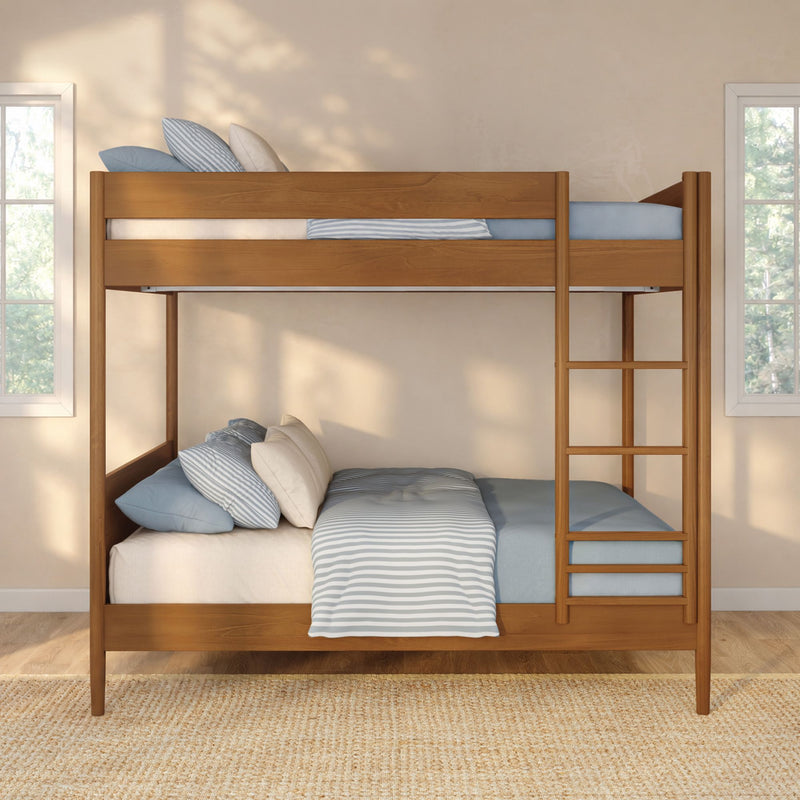 Solid wood twin-over-twin bunk bed with ladder and blue striped bedding in a bright sunlit modern kids' bedroom