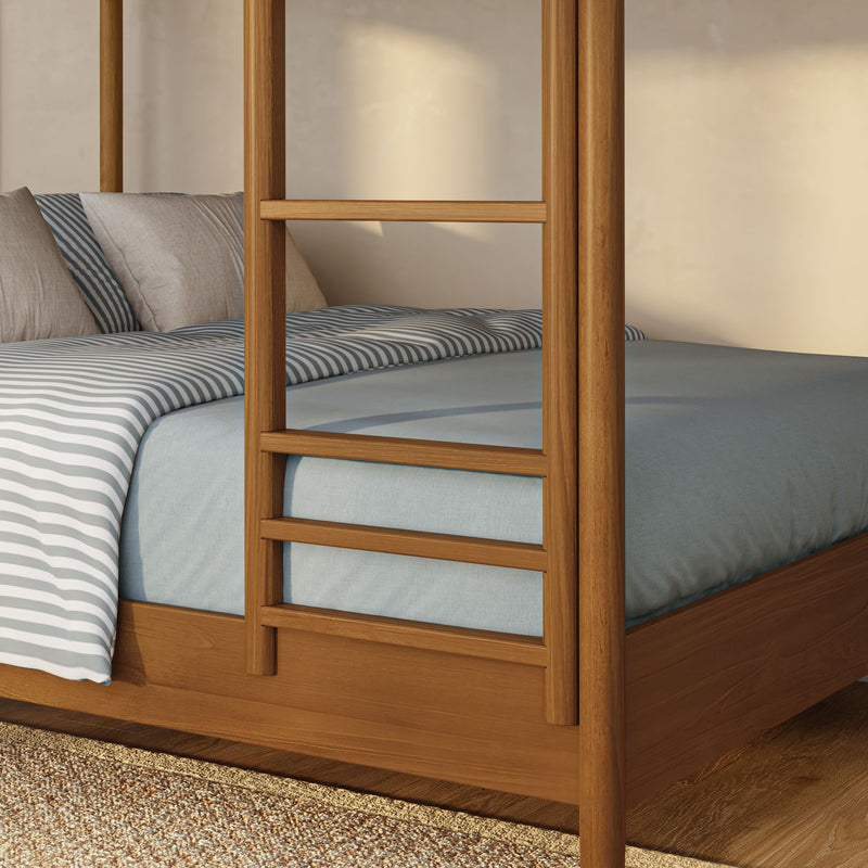 Close-up of wooden four‑poster bed ladder and frame with blue striped bedding and beige pillows in a modern rustic bedroom