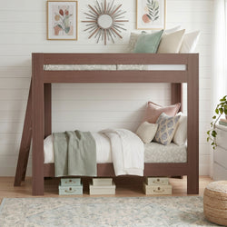 Wooden loft bunk bed with pastel pillows and mint knit throw in a farmhouse kids bedroom with shiplap wall, sunburst mirror, botanical prints and storage boxes underneath