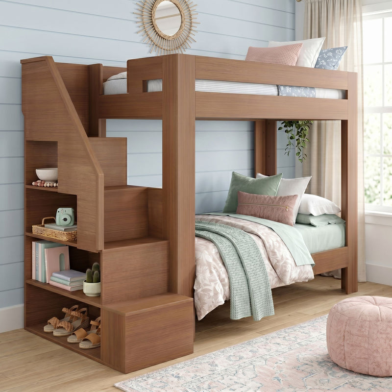 Solid wood loft bunk bed with built-in staircase storage, twin-over-twin beds styled with mint and blush bedding in a bright coastal kids' bedroom