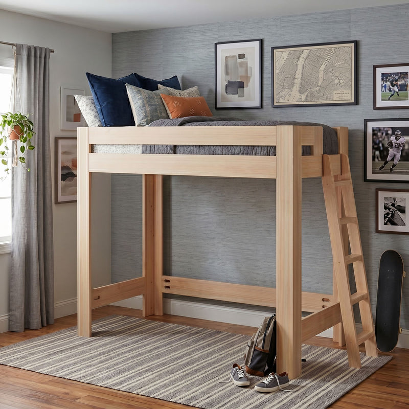 Modern natural wood loft bed with ladder and navy pillows in a styled kids' bedroom with framed art, striped rug, skateboard and hanging plant